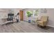 Bright bonus room featuring hardwood floors, natural light, a desk, and a sitting area, perfect for relaxing or working at 3501 Arrowwood Dr, Raleigh, NC 27604