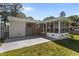 Backyard featuring a screen porch, paved area and a large lawn at 3501 Arrowwood Dr, Raleigh, NC 27604