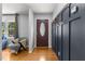 Bright foyer with hardwood floors, a cozy chair, and convenient coat hooks at 3501 Arrowwood Dr, Raleigh, NC 27604