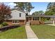 Charming home featuring a brick and vinyl exterior with a walkway and lush green lawn at 3501 Arrowwood Dr, Raleigh, NC 27604