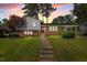Charming home featuring a brick and vinyl exterior with a walkway and lush green lawn at 3501 Arrowwood Dr, Raleigh, NC 27604