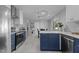 An open kitchen layout showcasing stainless steel appliances and a view into an adjacent dining area at 3501 Arrowwood Dr, Raleigh, NC 27604