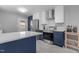 Bright kitchen with white countertops, stainless appliances, and blue lower cabinets at 3501 Arrowwood Dr, Raleigh, NC 27604