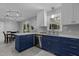 A well-lit kitchen featuring two-tone cabinetry, stainless steel appliances, and modern light fixture at 3501 Arrowwood Dr, Raleigh, NC 27604