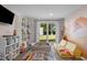 A playroom featuring a ball pit, colorful wall decor, a yellow sofa, and sliding glass doors to the outdoors at 3501 Arrowwood Dr, Raleigh, NC 27604