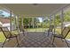 The screened porch features wood floors, four chairs, and views of the fenced backyard at 3501 Arrowwood Dr, Raleigh, NC 27604