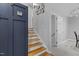 View of staircase with hardwood and white risers, accented by dark blue wall panels at 3501 Arrowwood Dr, Raleigh, NC 27604