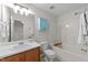 Comfortable bathroom featuring a shower and bath, a blue cabinet, and a wooden vanity at 3508 Oneonta Ave, Raleigh, NC 27604