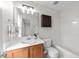 Well-lit bathroom with a vanity, dark wood storage cabinet, and a combined tub and shower unit at 3508 Oneonta Ave, Raleigh, NC 27604
