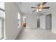 Spacious carpeted bedroom with a ceiling fan and attached bathroom and closet at 3508 Oneonta Ave, Raleigh, NC 27604