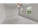 Light filled bedroom with plush carpet, a ceiling fan, and two windows for natural lighting at 3508 Oneonta Ave, Raleigh, NC 27604