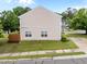 An exterior view of a townhome showing the side of the home and a glimpse of the backyard at 3508 Oneonta Ave, Raleigh, NC 27604