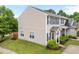 Side view of a well-maintained townhome featuring a lush lawn and mature landscaping at 3508 Oneonta Ave, Raleigh, NC 27604