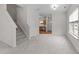 Open-concept living room featuring new carpet, freshly painted walls, and abundant natural light at 3508 Oneonta Ave, Raleigh, NC 27604