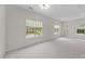 Bright living room featuring fresh paint, new carpet, and three large windows at 3508 Oneonta Ave, Raleigh, NC 27604