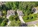 Aerial view of a suburban home surrounded by lush greenery and well-manicured lawns at 3612 Carriage Dr, Raleigh, NC 27612