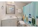 Bathroom featuring a single sink vanity, toilet, and bathtub with a surfboard-themed shower curtain at 3612 Carriage Dr, Raleigh, NC 27612