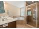 Luxurious bathroom featuring dual sinks, soaking tub, glass shower, and tile floors at 3612 Carriage Dr, Raleigh, NC 27612