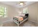 Comfortable bedroom features natural light and a ceiling fan at 3612 Carriage Dr, Raleigh, NC 27612