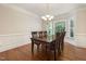 Traditional dining room features a wood table, six chairs, chandelier, and bay window at 3612 Carriage Dr, Raleigh, NC 27612