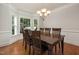 Bright dining room features a wood table, seating for six, a chandelier, and bay window at 3612 Carriage Dr, Raleigh, NC 27612