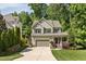 Charming two-story home featuring a manicured lawn, attached two-car garage, and traditional design elements at 3612 Carriage Dr, Raleigh, NC 27612