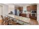 Modern kitchen with granite countertops, stainless steel appliances, and convenient breakfast bar seating at 3612 Carriage Dr, Raleigh, NC 27612
