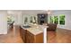Spacious living area with kitchen, hardwood floors, stone fireplace and many windows at 3612 Carriage Dr, Raleigh, NC 27612
