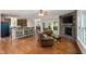 Open floor plan flows from kitchen to living room with stone fireplace and hardwood floors at 3612 Carriage Dr, Raleigh, NC 27612