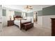 Comfortable main bedroom boasts soft carpet, a ceiling fan, and ensuite bathroom access at 3612 Carriage Dr, Raleigh, NC 27612