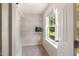 Well-lit walk-in closet with open wire shelving and a window at 3612 Carriage Dr, Raleigh, NC 27612