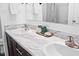 Modern bathroom showcasing double sinks with wood cabinets and all-white fixtures at 380 Perdues Rd, Louisburg, NC 27549