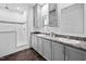 Bathroom featuring double sinks with gray cabinets, modern fixtures, granite countertops, and a glass shower at 380 Perdues Rd, Louisburg, NC 27549