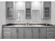 Bathroom boasting double sinks with gray cabinets and granite countertops, enhanced by natural light at 380 Perdues Rd, Louisburg, NC 27549