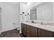 Modern bathroom showcasing double sinks with wood cabinets and a countertop with all-white fixtures at 380 Perdues Rd, Louisburg, NC 27549