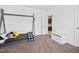 A bedroom with carpet flooring has an open door and a white toy chest at 380 Perdues Rd, Louisburg, NC 27549