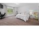 Bright bedroom with plush carpeting, large window, and neutral decor at 380 Perdues Rd, Louisburg, NC 27549