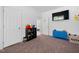 A room with a tv, toys and dark carpet at 380 Perdues Rd, Louisburg, NC 27549