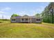Inviting single-story house with a cozy front porch, set on a lush green lawn under a clear blue sky at 380 Perdues Rd, Louisburg, NC 27549