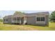 Charming single-story home with gray siding, a welcoming front porch, and well-maintained landscaping at 380 Perdues Rd, Louisburg, NC 27549