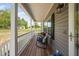 Quaint front porch with comfortable seating, ideal for enjoying the peaceful surroundings and outdoors at 380 Perdues Rd, Louisburg, NC 27549