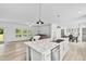 Open concept kitchen with island, seamlessly flowing into the living and dining areas at 380 Perdues Rd, Louisburg, NC 27549