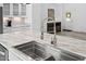Close-up of kitchen island with stainless steel sink and stylish faucet fixture detail at 380 Perdues Rd, Louisburg, NC 27549