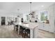 Bright kitchen features large island, stainless appliances, and seamless open floor plan at 380 Perdues Rd, Louisburg, NC 27549