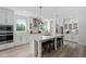 Well-lit kitchen boasts an island with stools, stainless appliances, and modern design elements at 380 Perdues Rd, Louisburg, NC 27549
