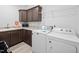 A laundry room has a sink, countertop, cabinets, and a white washing machine and dryer at 380 Perdues Rd, Louisburg, NC 27549