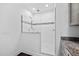 Shower room showcasing a glass door and marble-like tile complemented by modern fixtures and ample lighting at 380 Perdues Rd, Louisburg, NC 27549