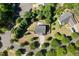 Aerial view of a house with a backyard firepit, surrounded by lush greenery and trees at 401 Onondaga Ct, Holly Springs, NC 27540