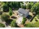 Aerial view of a home with a driveway and well-maintained backyard in a lush, green neighborhood at 401 Onondaga Ct, Holly Springs, NC 27540