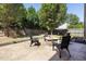Backyard view features a patio with a fire pit and landscaped areas, surrounded by trees at 401 Onondaga Ct, Holly Springs, NC 27540